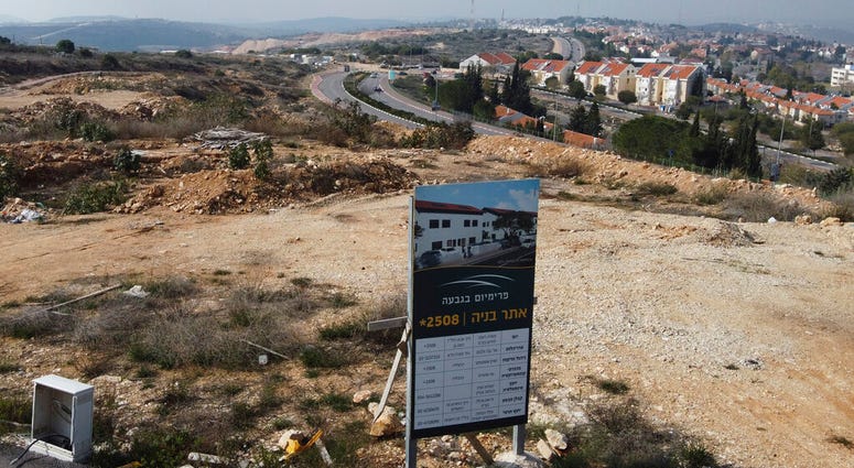 A new housing project sign stands in the Jewish West Bank settlement of Ari'el, Tuesday, Jan. 28, 2020. (AP Photo/Ariel Schalit) A new housing project sign stands in the Jewish West Bank settlement of Ari'el, Tuesday, Jan. 28, 2020. (AP Photo/Ariel Schalit)