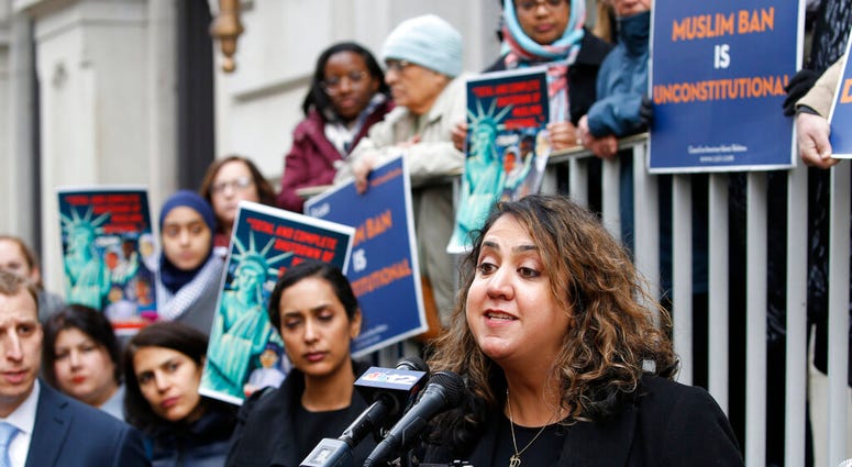 Plaintiff in the Muslim Ban Lawsuit, Mana Kharrazi, right, speaks during a rally outside the U.S. 4th Circuit Court of Appeals Tuesday Jan 28, 2020, in Richmond, Va. (AP Photo/Steve Helber) Plaintiff in the Muslim Ban Lawsuit, Mana Kharrazi, right, speaks during a rally outside the U.S. 4th Circuit Court of Appeals Tuesday Jan 28, 2020, in Richmond, Va. (AP Photo/Steve Helber)