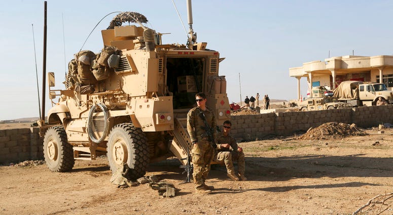 In this Feb. 23, 2017 file photo, U.S. Army soldiers stand outside their armored vehicle on a joint base with the Iraqi army, south of Mosul, Iraq. (AP Photo/ Khalid Mohammed, File) In this Feb. 23, 2017 file photo, U.S. Army soldiers stand outside their armored vehicle on a joint base with the Iraqi army, south of Mosul, Iraq. (AP Photo/ Khalid Mohammed, File)