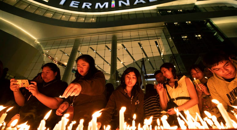 People attend a memorial service at the Terminal 21 Korat shopping mall in Nakhon Ratchasima, Thailand, Monday, Feb. 10, 2020. (AP Photo/Sakchai Lalit) People attend a memorial service at the Terminal 21 Korat shopping mall in Nakhon Ratchasima, Thailand, Monday, Feb. 10, 2020. (AP Photo/Sakchai Lalit)