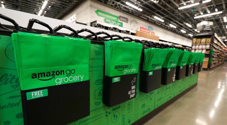 In this Feb. 21, 2020 photo, reusable shopping bags are displayed inside an Amazon Go Grocery store set to open soon in Seattle's Capitol Hill neighborhood. (AP Photo/Ted S. Warren) In this Feb. 21, 2020 photo, reusable shopping bags are displayed inside an Amazon Go Grocery store set to open soon in Seattle's Capitol Hill neighborhood. (AP Photo/Ted S. Warren)