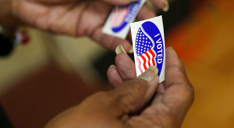 An election officer passes out "I Voted" stickers during the Super Tuesday primary at at Lincoln Terrace Elementary School. (Heather Rousseau/The Roanoke Times via AP) An election officer passes out "I Voted" stickers during the Super Tuesday primary at at Lincoln Terrace Elementary School. (Heather Rousseau/The Roanoke Times via AP)
