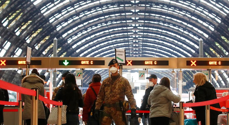 Police officers and soldiers check passengers leaving from Milan main train station, Italy, Monday, March 9, 2020. (AP Photo/Antonio Calanni) Police officers and soldiers check passengers leaving from Milan main train station, Italy, Monday, March 9, 2020. (AP Photo/Antonio Calanni)