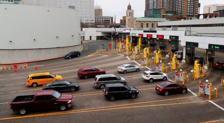Vehicles enter the United States as a minivan drives to Canada in the Detroit-Windsor Tunnel in Detroit, Monday, March 16, 2020. (AP Photo/Paul Sancya) Vehicles enter the United States as a minivan drives to Canada in the Detroit-Windsor Tunnel in Detroit, Monday, March 16, 2020. (AP Photo/Paul Sancya)