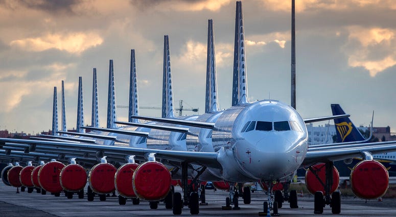 Vueling Airlines planes sit parked in a line at the Seville, Spain airport on Saturday, March 21, 2020, idled due to the COVID-19 coronavirus outbreak. (AP Photo/Miguel Morenatti) Vueling Airlines planes sit parked in a line at the Seville, Spain airport on Saturday, March 21, 2020, idled due to the COVID-19 coronavirus outbreak. (AP Photo/Miguel Morenatti)
