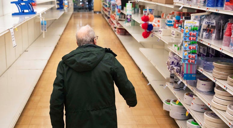 In this March 19, 2020 photo, a shopper looks for toilet paper at a Stop & Shop supermarket during hours open daily only for seniors in North Providence, R.I. (AP Photo/David Goldman) In this March 19, 2020 photo, a shopper looks for toilet paper at a Stop & Shop supermarket during hours open daily only for seniors in North Providence, R.I. (AP Photo/David Goldman)