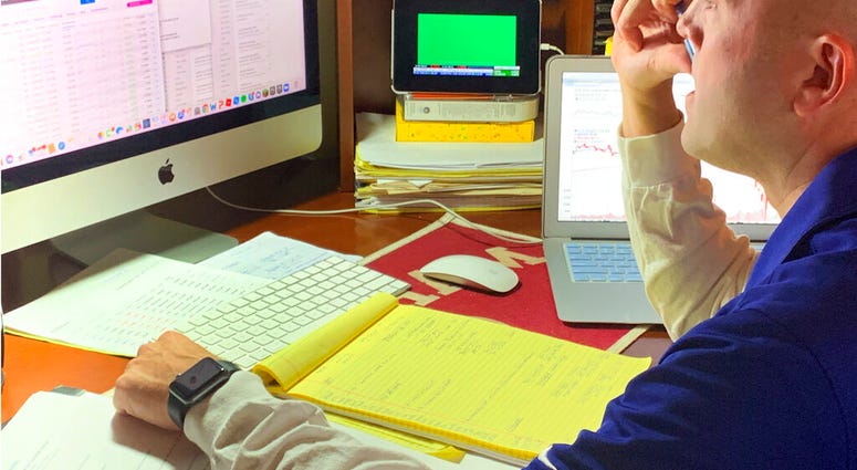 In this image provided by Jay Woods, Woods, a Designated Market Maker with IMC and NYSE Floor Governor, who normally works on the New York Stock Exchange trading floor, works in his home office in Basking Ridge, N.J., Thursday, March 26, 2020.