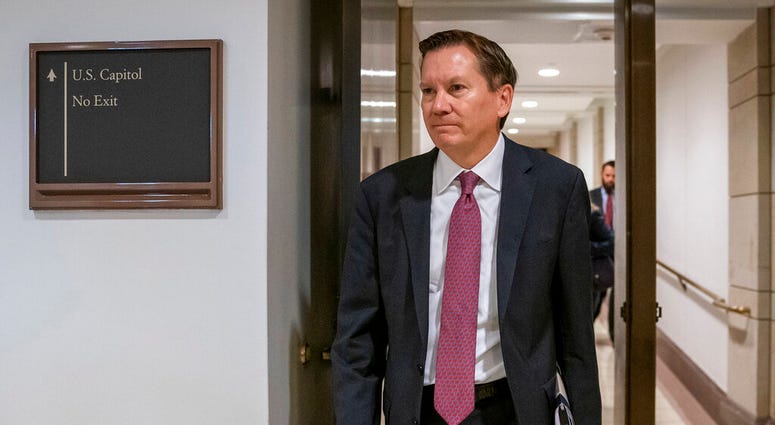 FILE - In this Oct. 4, 2019, file photo, Michael Atkinson, the inspector general of the intelligence community, arrives at the Capitol in Washington for closed-door questioning about a whistleblower complaint that triggered President Donald Trump's impeac