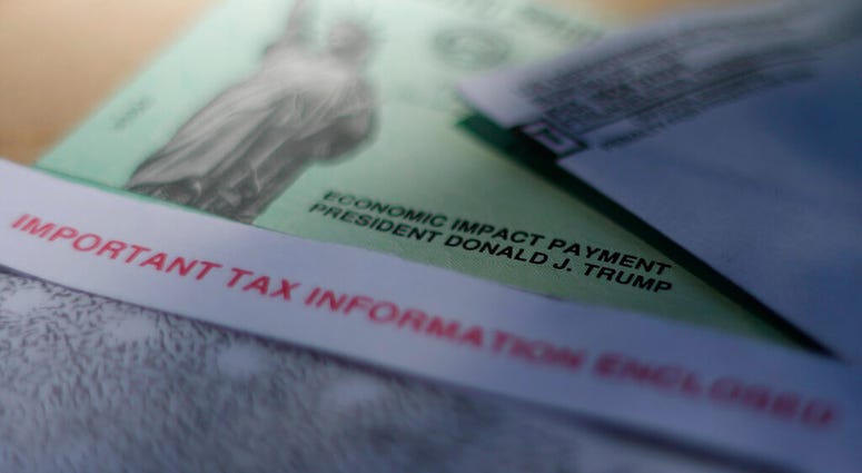 FILE - This April 23, 2020, file photo shows President Donald J. Trump's name printed on a stimulus check issued by the IRS to help combat the adverse economic effects of the new coronavirus outbreak in San Antonio. (AP Photo/Eric Gay, File) FILE - This April 23, 2020, file photo shows President Donald J. Trump's name printed on a stimulus check issued by the IRS to help combat the adverse economic effects of the new coronavirus outbreak in San Antonio. (AP Photo/Eric Gay, File)