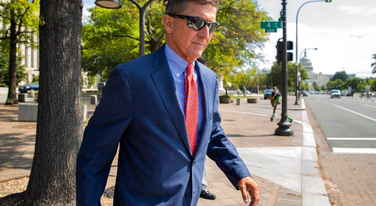 FILE - In this Sept. 10, 2019 file photo, Michael Flynn, President Donald Trump's former national security adviser, leaves the federal court following a status conference in Washington.
