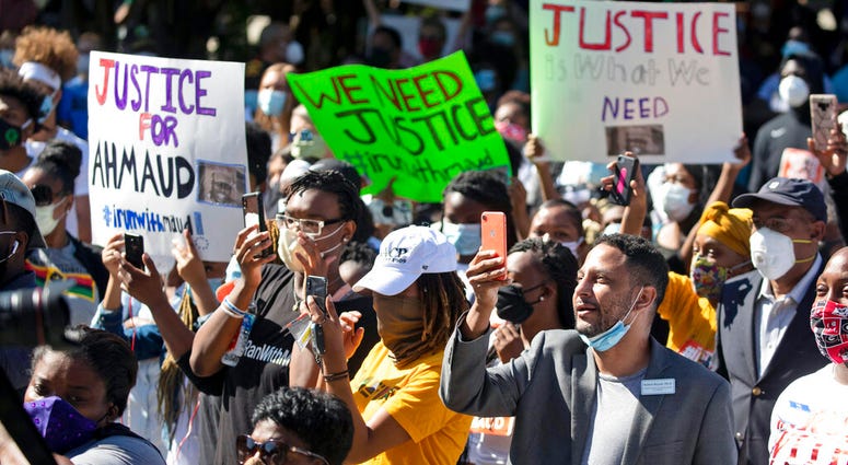 People react during a rally to protest the shooting of Ahmaud Arbery, Friday, May 8, 2020, in Brunswick Ga. Two men have been charged with murder