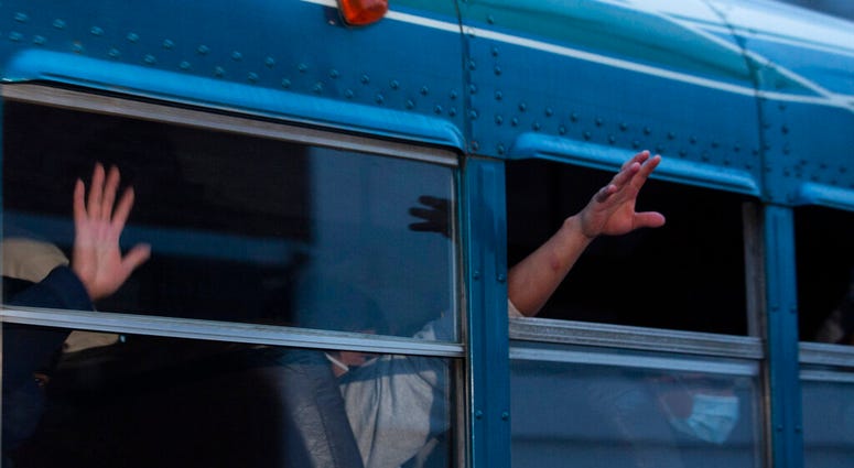 In this May 4, 2020, file photo, Guatemalans deported from the U.S., wave from a bus after arriving at La Aurora airport in Guatemala City. (AP Photo/Moises Castillo, File) In this May 4, 2020, file photo, Guatemalans deported from the U.S., wave from a bus after arriving at La Aurora airport in Guatemala City. (AP Photo/Moises Castillo, File)