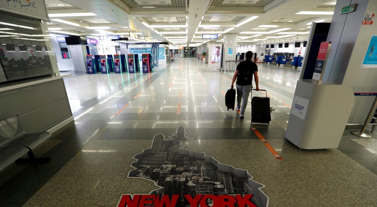 A passenger walks through the Belgrade Nikola Tesla Airport, Serbia, Monday, May 18, 2020.