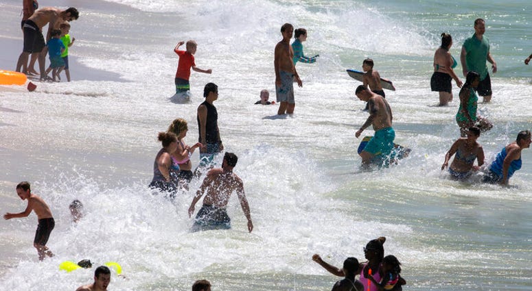 People enjoy Pensacola Beach in Pensacola, Fla., Saturday, May 23, 2020, during the coronavirus pandemic.