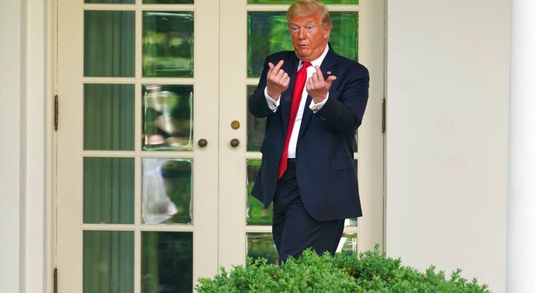 President Donald Trump gestures to people in the audience after an event on protecting seniors with diabetes in the Rose Garden White House, Tuesday, May 26, 2020, in Washington. (