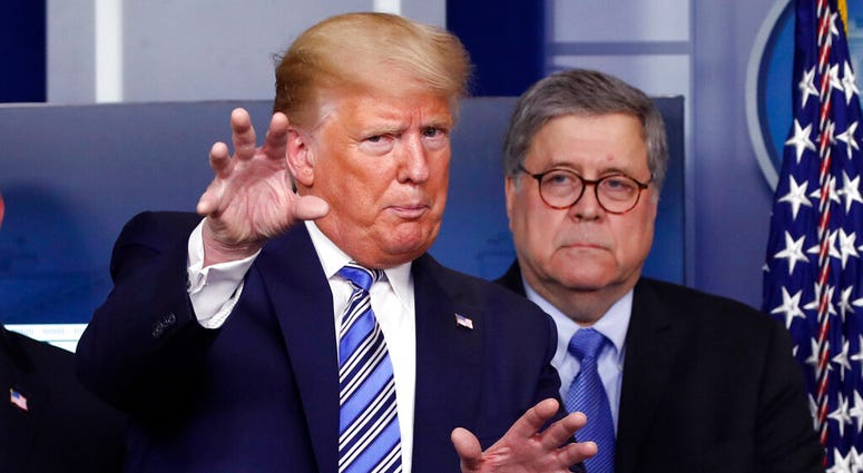 FILE- In this March 23, 2020 file photo, President Donald Trump talks during a briefing about the coronavirus in the James Brady Briefing Room, Monday, March 23, 2020, in Washington, as Attorney General William Barr looks on.