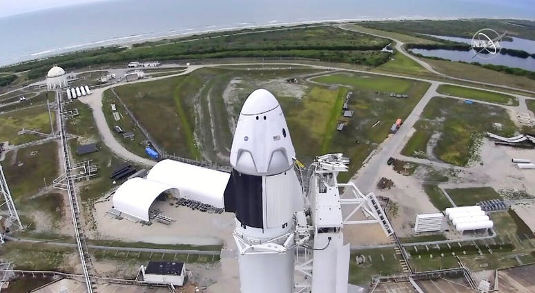 In this image made from video via NASA-TV, a SpaceX Falcon 9, with NASA astronauts Doug Hurley and Bob Behnken in the Dragon crew capsule, prepare to lift off from Pad 39-A at the Kennedy Space Center in Cape Canaveral, Fla., Wednesday, May 27, 2020.