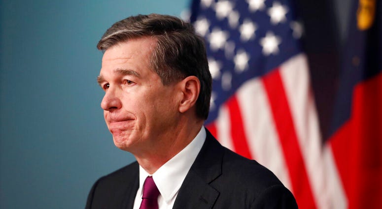 North Carolina Gov. Roy Cooper listens to a question during a briefing on the coronavirus pandemic at the Emergency Operations Center in Raleigh, N.C., Thursday, May 28, 2020.