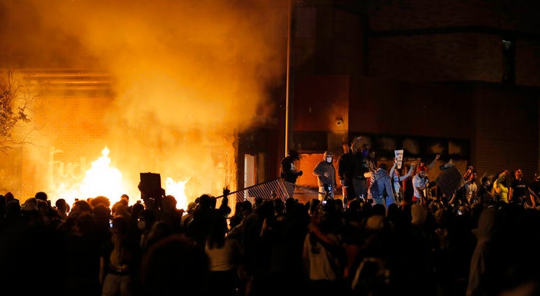 Protesters gather in front of the burning Minneapolis police 3rd Precinct building Thursday, May 28, 2020, in Minneapolis. (AP Photo/Julio Cortez) Protesters gather in front of the burning Minneapolis police 3rd Precinct building Thursday, May 28, 2020, in Minneapolis. (AP Photo/Julio Cortez)