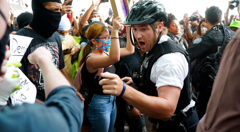 Demonstrators argue with uniformed U.S Secret Service police officers during a protest about the death of George Floyd, a black man who died in police custody in Minneapolis, Friday, May 29, 2020, in Washington.
