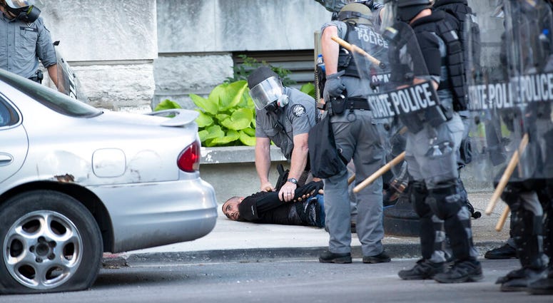 Kentucky State Police detain a man on West Liberty Street on Sunday, May 31, 2020, in downtown Louisville, Kentucky.