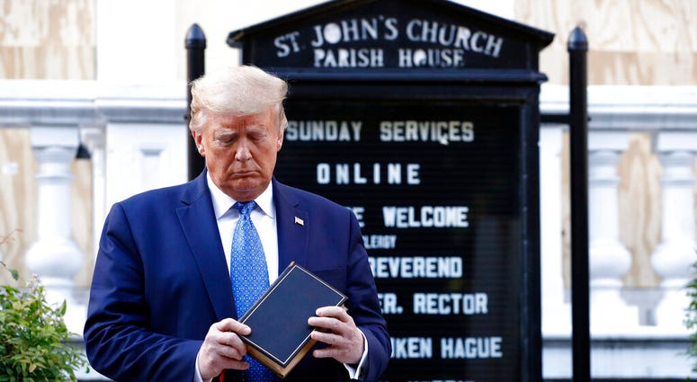 President Donald Trump holds a Bible as he visits outside St. John's Church across Lafayette Park from the White House Monday, June 1, 2020, in Washington. Part of the church was set on fire during protests on Sunday night.