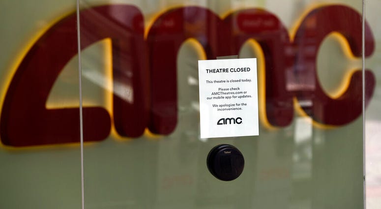 FILE - In this April 29, 2020 file photo, a message on the ticket window at the AMC Burbank 16 movie theaters complex informs potential customers that it is currently closed in Burbank, Calif.