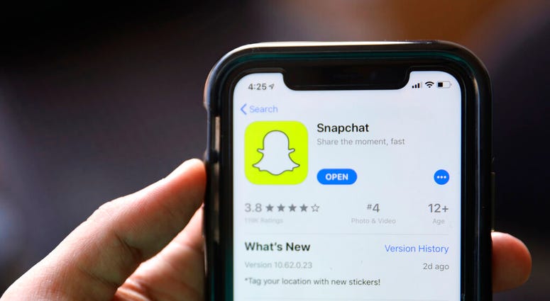 FILE - This July 30, 2019, file photo shows an introduction page for Snapchat shown in a mobile phone displayed at Apple's App Store in Chicago.