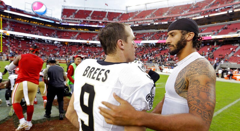 FILE - In this Nov. 6, 2016, file photo, San Francisco 49ers quarterback Colin Kaepernick, right, is greeted by New Orleans Saints quarterback Drew Brees at the end of an NFL football game in Santa Clara, Calif.