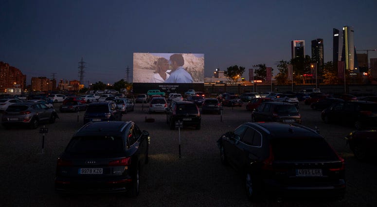 Moviegoers watch the movie "Grease" at the Autocine Madrid Race drive-in cinema during the coronavirus outbreak in Madrid, Spain, Thursday, June 4, 2020.