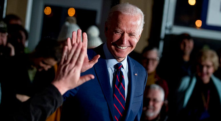FILE - In this Jan. 5, 2020, file photo Democratic presidential candidate, former Vice President Joe Biden high-fives a member of the audience during a campaign rally at Modern Woodmen Park in Davenport, Iowa
