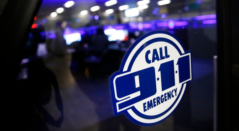 FILE - This May 3, 2019, file photo shows a police 911 call center. Jobs with state and city governments are usually a source of stability in the U.S. economy, but the financial devastation wrought by the coronavirus pandemic has forced cuts that will red