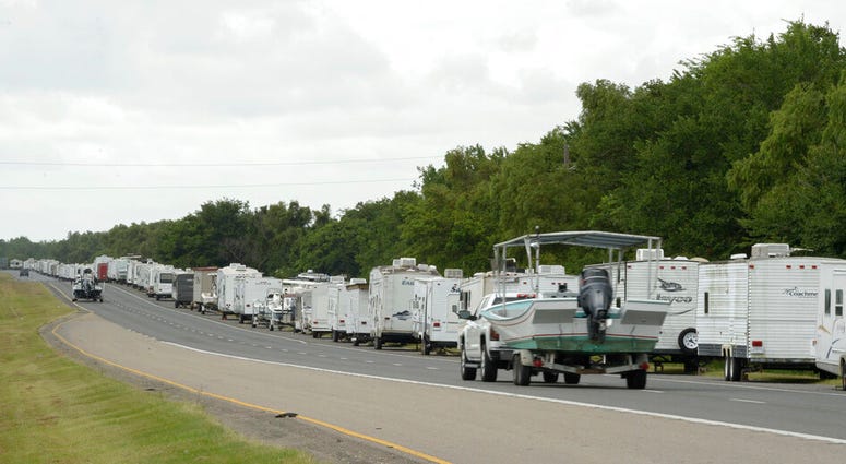 Recreational trailers and boats are parked along LA-46 inside the levee gates in anticipation of Tropical Storm Cristobal in St. Bernard Parish, La., Saturday, June 6, 2020.