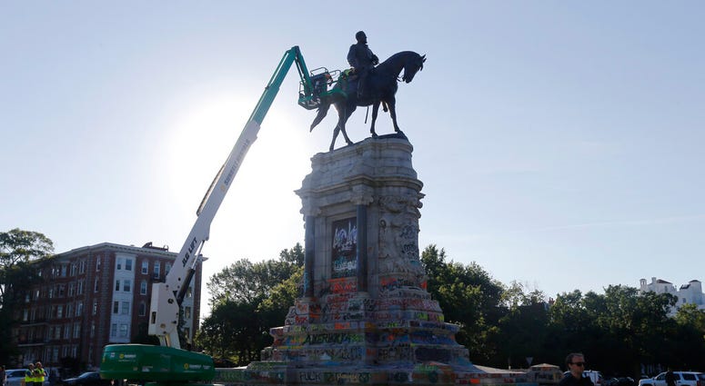 An inspection crew from the Virginia Department of General Services inspect the statue of Confederate Gen. Robert E. Lee on Monument Avenue Monday June. 8, 2020, in Richmond, Va. (AP Photo/Steve Helber) An inspection crew from the Virginia Department of General Services inspect the statue of Confederate Gen. Robert E. Lee on Monument Avenue Monday June. 8, 2020, in Richmond, Va. (AP Photo/Steve Helber)