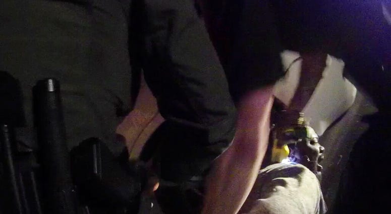 In this image made from a March 28, 2019, body-worn camera video provided by the Austin Police Department in Texas, Williamson County deputies hold down Javier Ambler as one of them uses a Taser on Ambler’s back during his arrest in Austin, Texas.