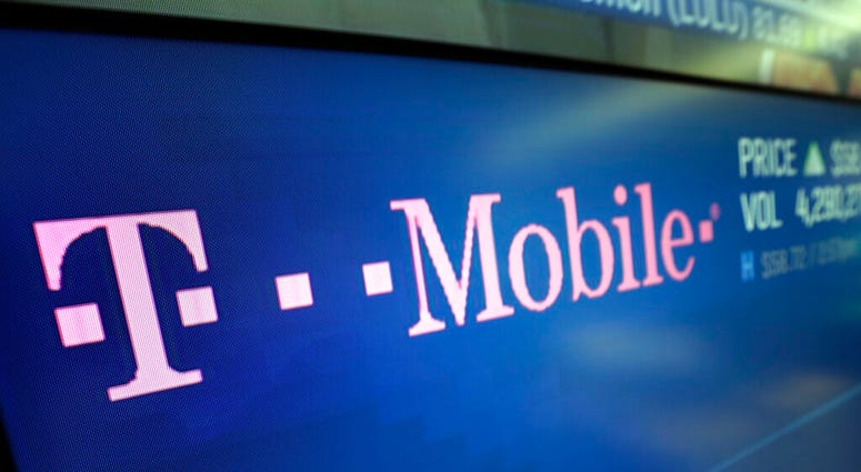 In this Feb. 14, 2018, photo, the logo for T-Mobile appears on a screen at the Nasdaq MarketSite in New York. T-Mobile, one of the three largest mobile carriers in the U.S., said it's working to fix a widespread network issue.