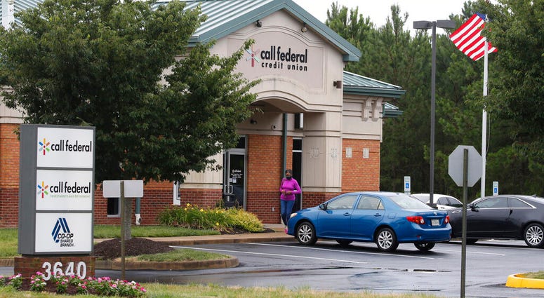 A customer walks out of the Call Federal Credit Union building Tuesday, June 16, 2020, in Midlothian, Va.