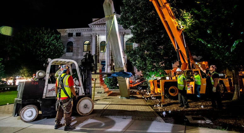 Workers remove a Confederate monument with a crane Thursday, June 18, 2020, in Decatur, Ga.