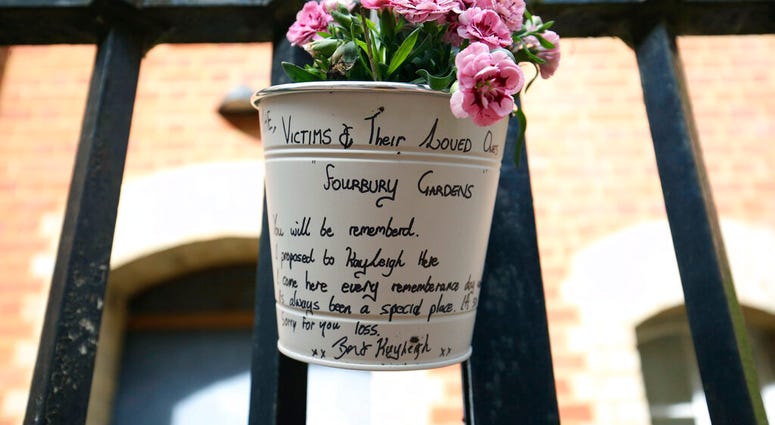 A floral tribute and message left at the Abbey gateway of Forbury Gardens following a multiple stabbing attack in the gardens, in Reading, England, Sunday June 21, 2020.