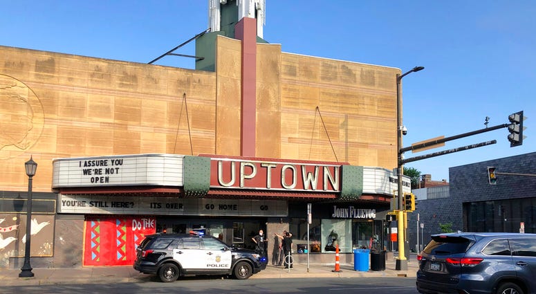 A police vehicle is parked outside the Uptown Theatre Sunday, June 21, 2020, following a shooting in Minneapolis' Uptown neighborhood. Multiple people were shot, one fatally, when gunfire broke out shortly after midnight Sunday.