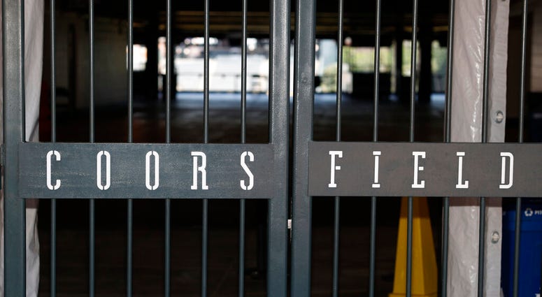 The main gate of Coors Field, home of the Major League Baseball team the Colorado Rockies, is locked early Tuesday, June 23, 2020, in Denver.
