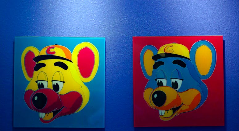FILE - This Jan. 16, 2014 file photo shows paintings hanging on a wall at Chuck E. Cheese's in Dallas.