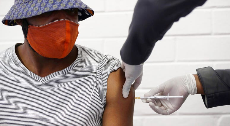 FILE - In this Wednesday, June 24, 2020 file photo, a volunteer receives a COVID-19 test vaccine injection developed at the University of Oxford in Britain, at the Chris Hani Baragwanath hospital in Soweto, Johannesburg, South Africa.