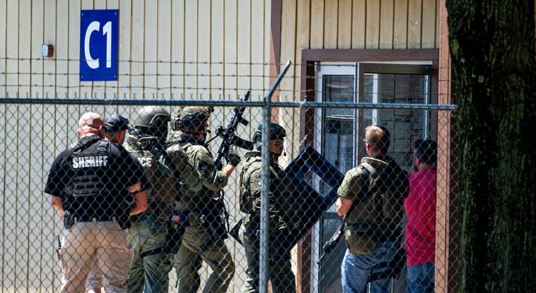 Law enforcement enter the C1 building to the west of the Bunn-O-Matic warehouse during an active shooter situation, Friday, June 26, 2020, in Springfield, Ill.