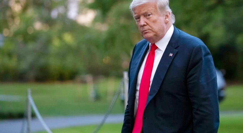 FILE- In this Thursday, June 25, 2020, file photo, President Donald Trump walks on the South Lawn after arriving on Marine One at the White House in Washington.