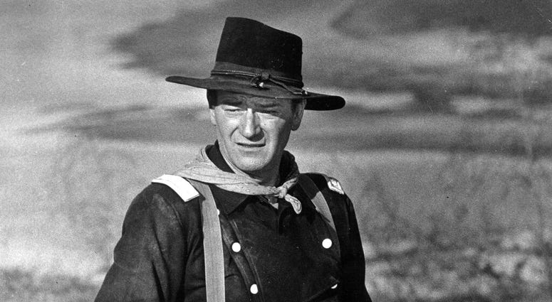 FILE - In this undated photo, John Wayne appears during the filming of "The Horse Soldiers." In the latest move to change place names in light of U.S. racial history, leaders of Orange County’s Democratic Party are pushing to drop film legend Wayne’s name