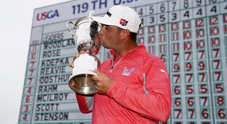 FILE - In this June 16, 2019, file photo, Gary Woodland poses with the trophy after winning the U.S. Open golf tournament in Pebble Beach, Calif.