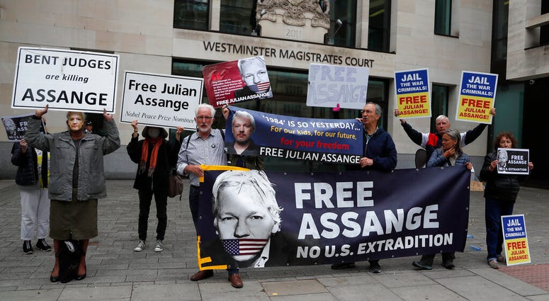 Supporters of WikiLeaks founder Julian Assange protest in front of Westminster Magistrates' Court in London, Monday, June 29, 2020, where he is expected to appear in custody for the extradition case management hearing.