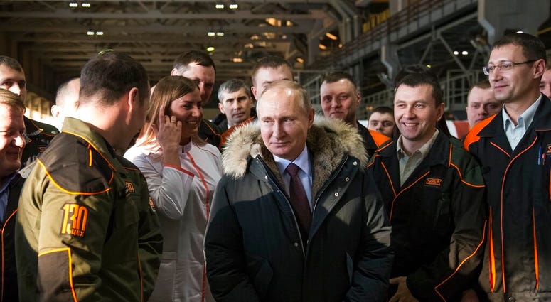 FILE - In this March 6, 2018, file photo, Russian President Vladimir Putin listens to employees of Uralvagonzavod factory in Nizhny Tagil, Russia.