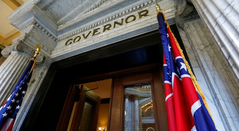 The Mississippi state flag is shown across from the American flag, outside the Governor's Office at the Capitol in Jackson, Miss., Monday, June 29, 2020, the day after both chambers of the state Legislature passed a bill to take down and replace the curre